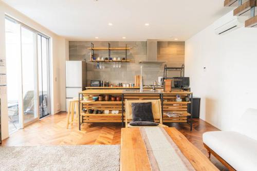 a living room with a kitchen with a table at unito Villa FUTTSU Takeoka in Futtsu