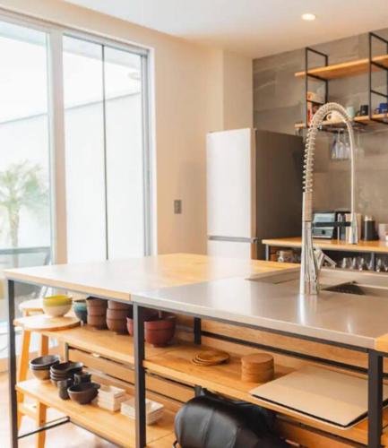 a kitchen with a table and a counter top at unito Villa FUTTSU Takeoka in Futtsu