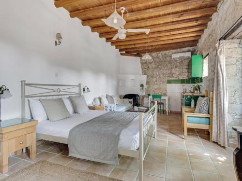 a bedroom with a bed and a living room at Cornaro House in Arsos