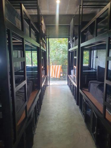 a hallway of a room with lots of bunk beds at Deishaview Jungle Hostel in Koh Tao
