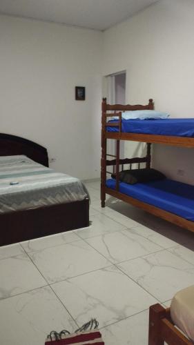 a bedroom with two bunk beds in a room at Equilibra Soul in Caraguatatuba