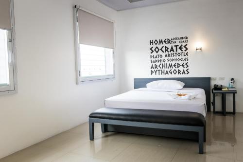 a bedroom with a bed and a wall with writing on it at GC Suites in Cagayan de Oro