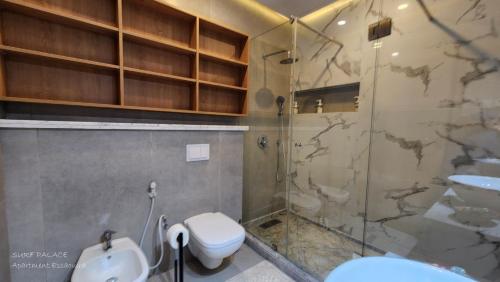 a bathroom with a shower and a toilet and a sink at SURF PALACE BEACHFRONT APARTMENT Essaouira in Essaouira