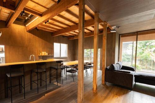 a kitchen and dining room with a bar in a house at unito 逗子別邸 in Zushi