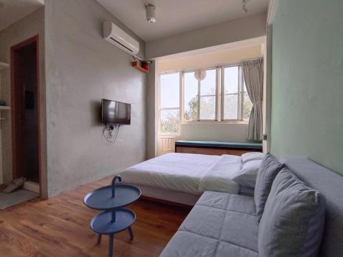 Postel nebo postele na pokoji v ubytování 東海小時光 Tong Hai Time Homestay