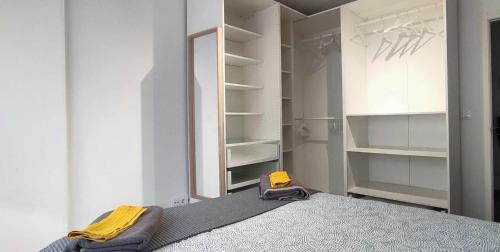 a bedroom with a bed and a mirror and shelves at Apartamento en Ultramar in Ferrol