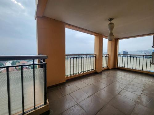 a balcony with a view of the ocean from a building at Penthouse Grand Setiabudi Apartment Bandung in Bandung