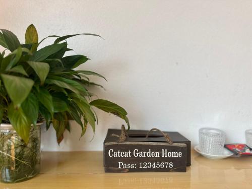 a plant and a sign for a garden garden home on a table at Catcat Garden House in Sa Pa