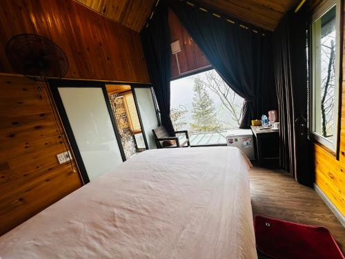 a bedroom with a large bed and a window at Catcat Garden House in Sa Pa