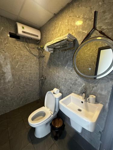 a bathroom with a sink and a toilet and a mirror at Catcat Garden House in Sa Pa