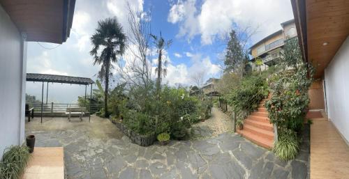 a house with a garden with trees and plants at Catcat Garden House in Sa Pa