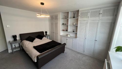 a bedroom with a bed and a book shelf at Cosy Corner in Midhurst