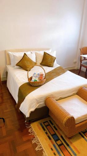 a large bed with a basket on top of it at 12/14 HOME Studio in Bangkok
