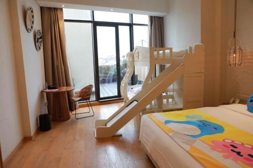 a bedroom with a bunk bed with a ladder at Manli Hotel Shanghai Pudong Airport Branch -Provide free shuttle buses to Pudong Airport and Disneyland in Shanghai