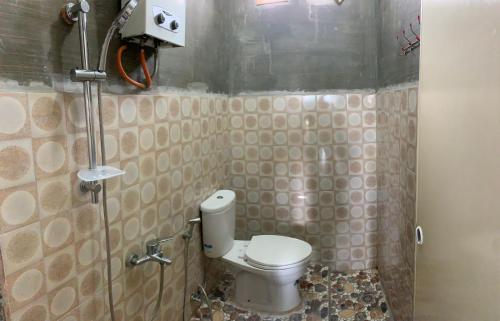W niewielkim pokoju znajduje się łazienka z toaletą. w obiekcie Guest House karohill w mieście Berastagi