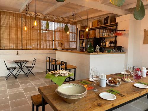 a kitchen and dining room with a wooden table at Tenuta Amostuni-Country House in Ostuni