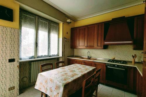 a kitchen with a table with a table cloth on it at Flat 15km Airport Milan BGY in Cologno al Serio