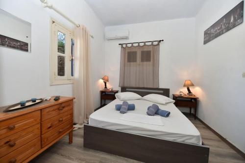 una camera con letto, cassettiera e lavandino di La Casa Di Maryolo Zannel seaside serenity a Kardhianí