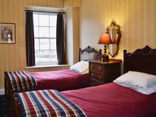 a bedroom with two beds and a window at Nelson - Fdg in Ilfracombe