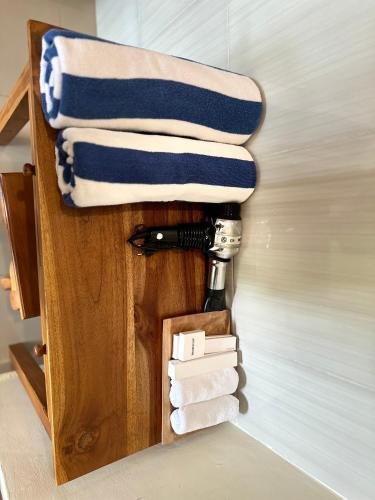 a towel rack with towels and a bottle of wine at Saputra Guesthouse in Ubud