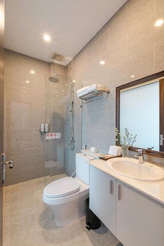a bathroom with a toilet and a sink and a shower at PINE VIEW Hotel Dalat in Da Lat