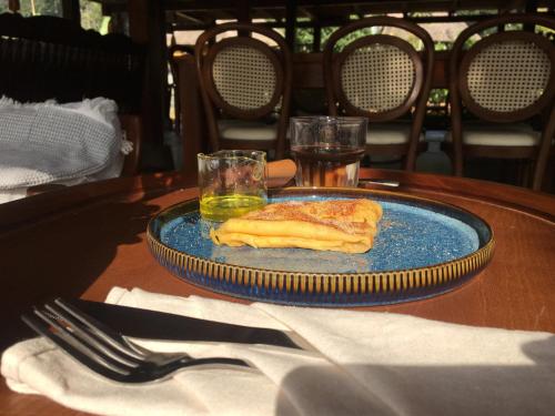 a blue plate with a piece of food on a table at Thavill Retreat HaGiang in Ha Giang