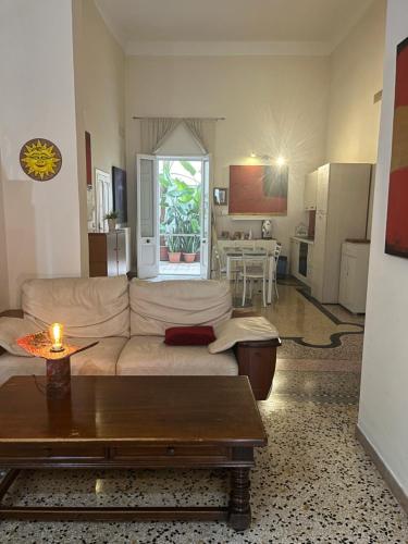 Una sala de estar con un sofá blanco y una mesa. en Salento b&b Trepuzzi, en Trepuzzi