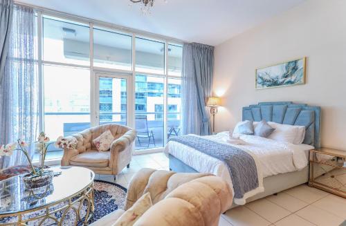 a bedroom with a bed and a large window at Elite LUX Holiday Homes - Bay Square Luxury Studio in Business Bay Dubai in Dubai