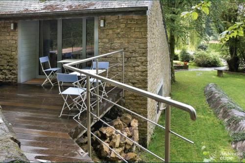 a metal railing on a patio with chairs and a table at Les Braises de la Semois in Florenville