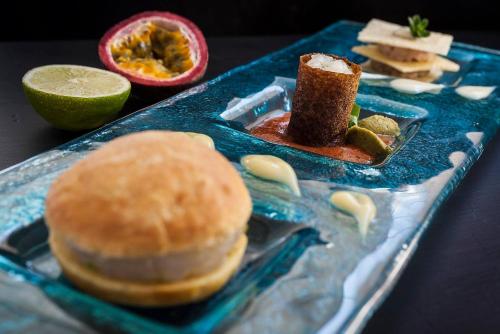 a blue plate of food with a sandwich and a hamburger at Hotel Terme Cristallo Palace & Beach in Ischia