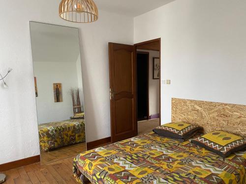 a bedroom with a bed with two pillows on it at Résidence Beausoleil in Creuzier-le-Vieux