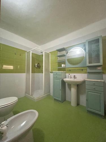a bathroom with a toilet and a sink and a shower at Salento b&b Trepuzzi in Trepuzzi
