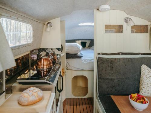 a kitchen with an oven and a table in a caravan at Chere Amie-qu7616 in Melton Constable