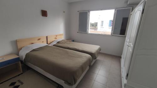 Ein Bett oder Betten in einem Zimmer der Unterkunft CoZi Coliving Djerba