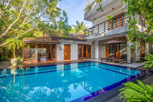 an exterior view of a villa with a swimming pool at Royal Villa in Weligama