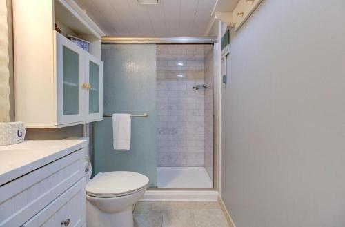 a white bathroom with a shower and a toilet at 0305 Mako Your Dreams Come True by Atlantic Towers in Carolina Beach