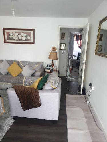 a living room with a white couch with pillows at Residential property in Edmonton