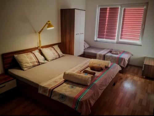 a bedroom with two beds and a couch at Sky Apartments in Strumica