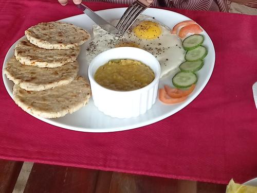 a plate of food with eggs and vegetables on a table at La-Vira Beach Villa in Hikkaduwa