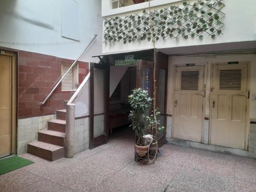 a building with stairs and a door and a plant at NEW KHUSHDIL HOTEL in New Delhi