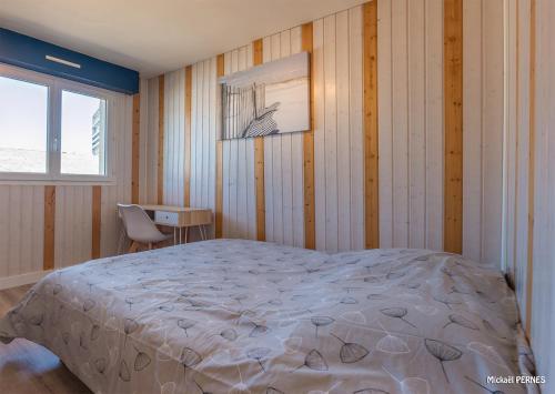 um quarto com uma cama, uma secretária e uma janela em RÉF 383 - LORIENT Appartement duplex type 3 avec 2 parkings em Lorient