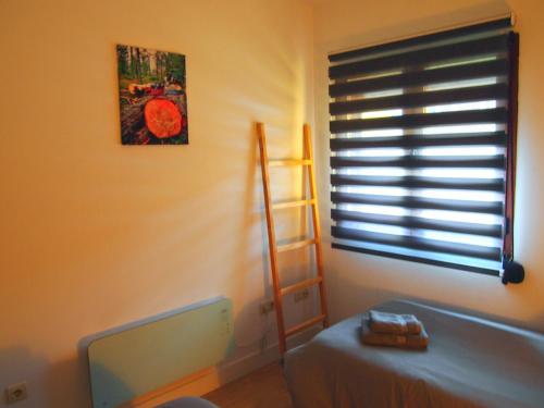a room with a window with a ladder and a monitor at Alojamiento Rural Los Hacheros in Tragacete