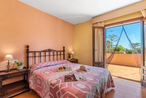 a bedroom with a bed and a large window at Villa Benimarco - PlusHolidays in Benissa