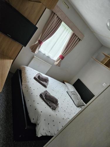 a small bed in a small room with a window at 53 Kingsgate Lower Hyde in Shanklin