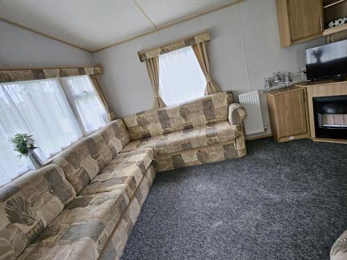 a living room with a couch and a tv at 53 Kingsgate Lower Hyde in Shanklin