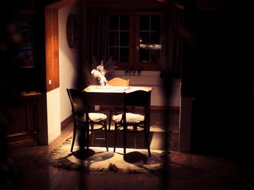 a dining room table with two chairs in a kitchen at Boutique Hotel La Cabane in Bettmeralp