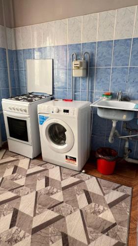 a kitchen with a washing machine and a sink at Квартира однокомнатная in Taraz