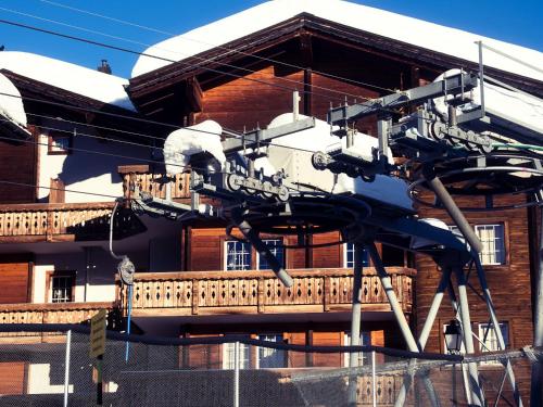 a large sculpture of a machine on the side of a building at Boutique Hotel La Cabane in Bettmeralp