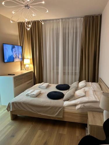a bedroom with a large bed with pillows on it at Willa Jelitkowska in Gdańsk