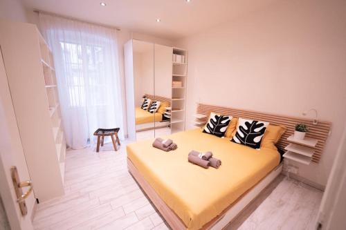 ein Schlafzimmer mit einem großen gelben Bett mit Kissen in der Unterkunft La Rosa Dei Venti Comfort Home in Triest